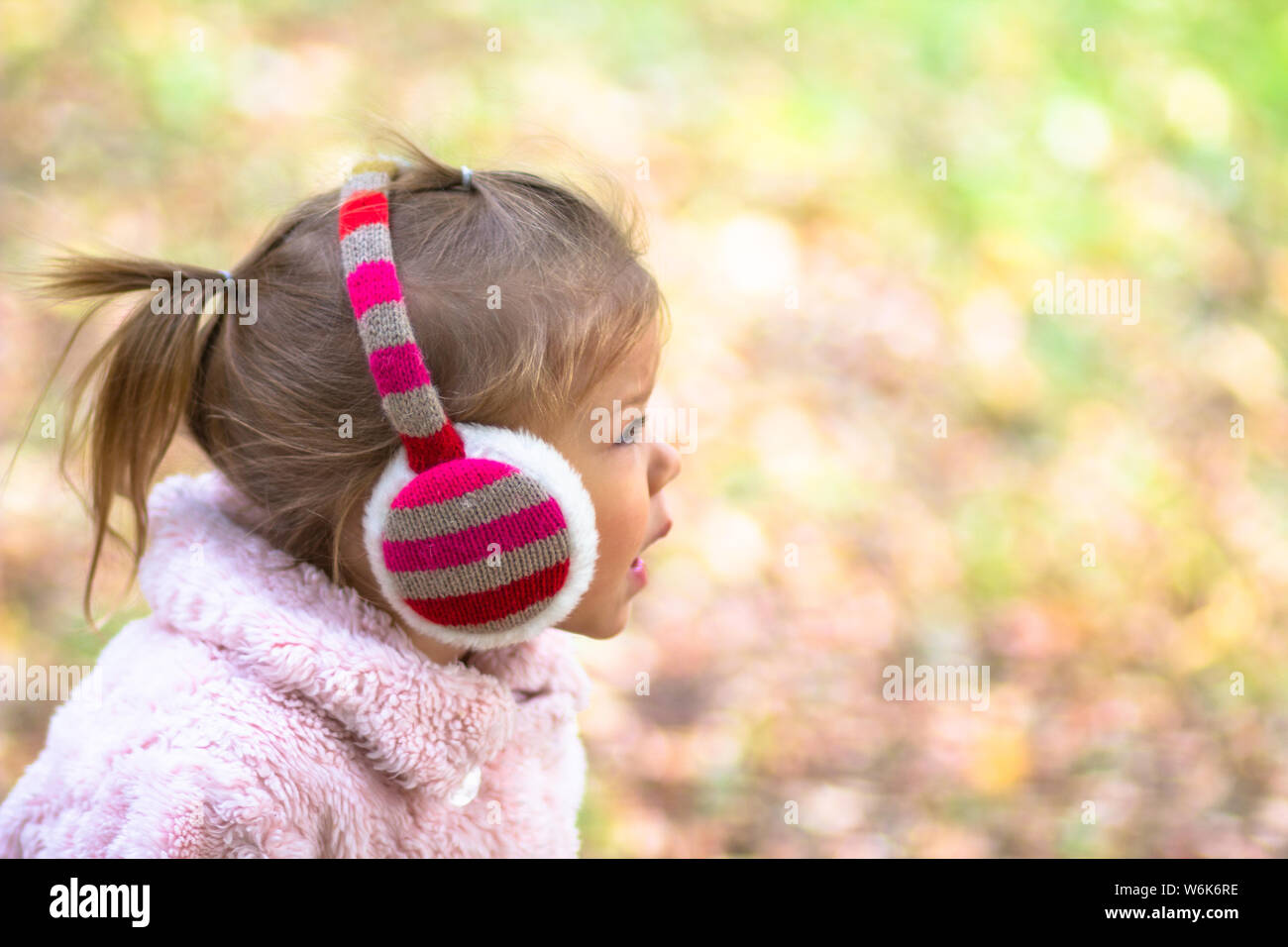 Little girl in the autumn park Stock Photo - Alamy
