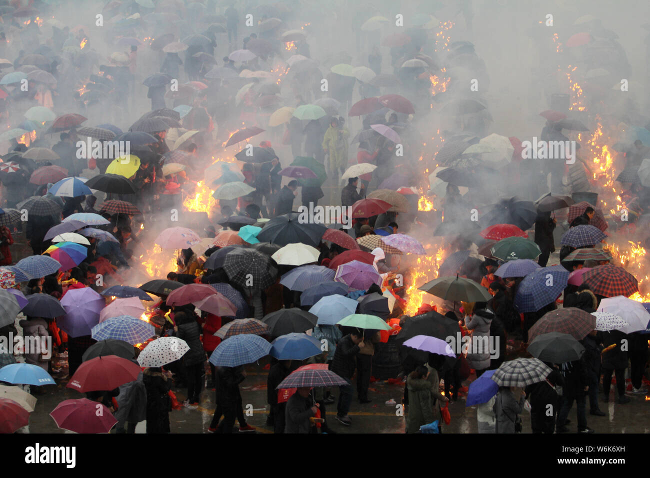 Chinese worshippers burn incense sticks to pray for wealth and ...