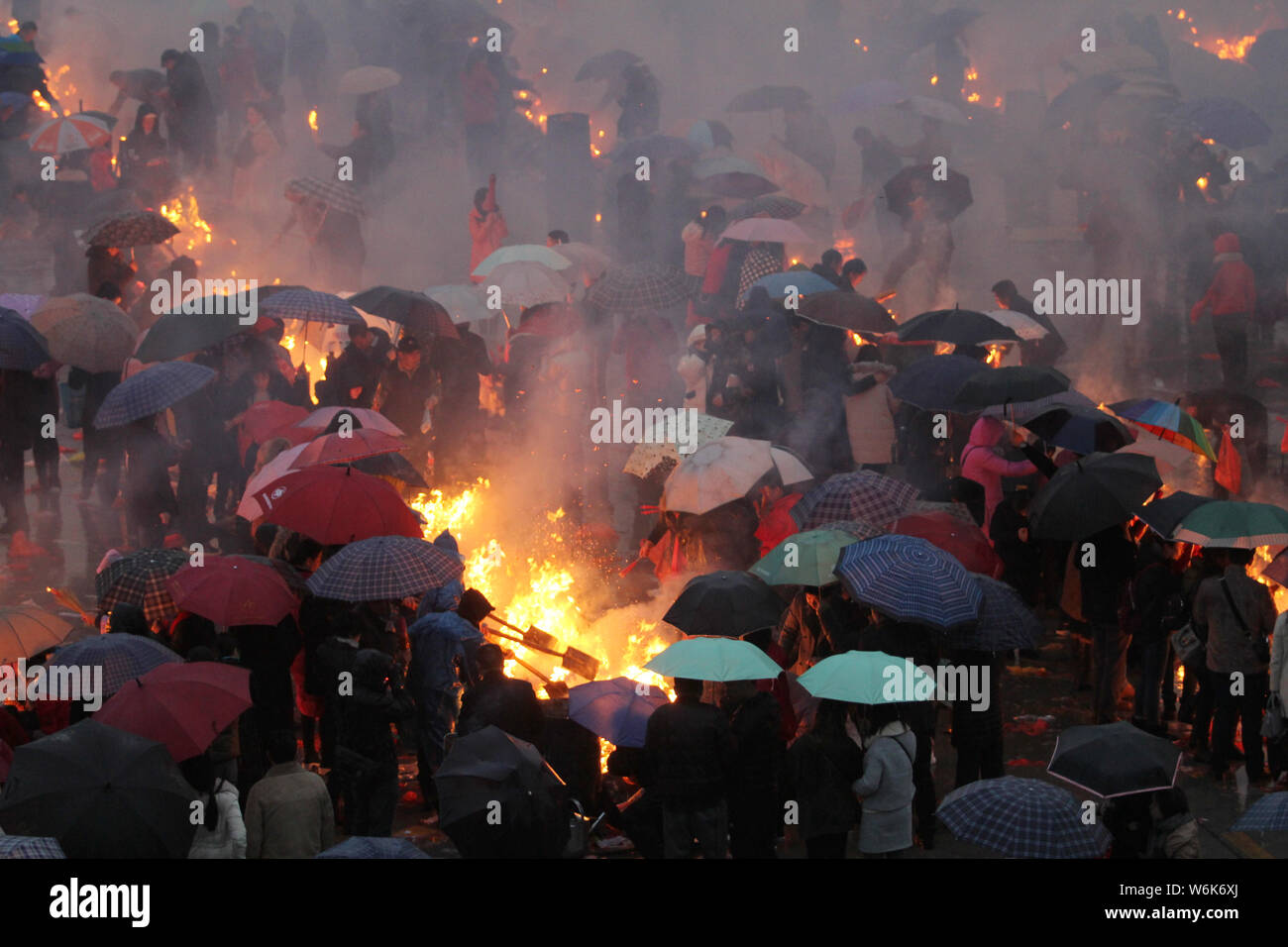 Chinese worshippers burn incense sticks to pray for wealth and ...