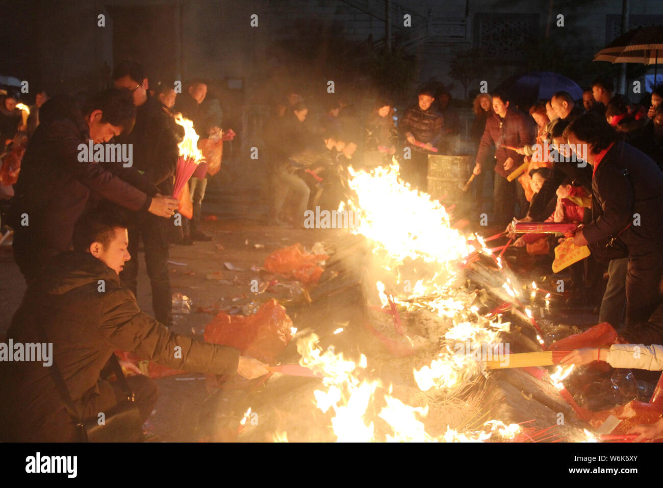 Chinese worshippers burn incense sticks to pray for wealth and