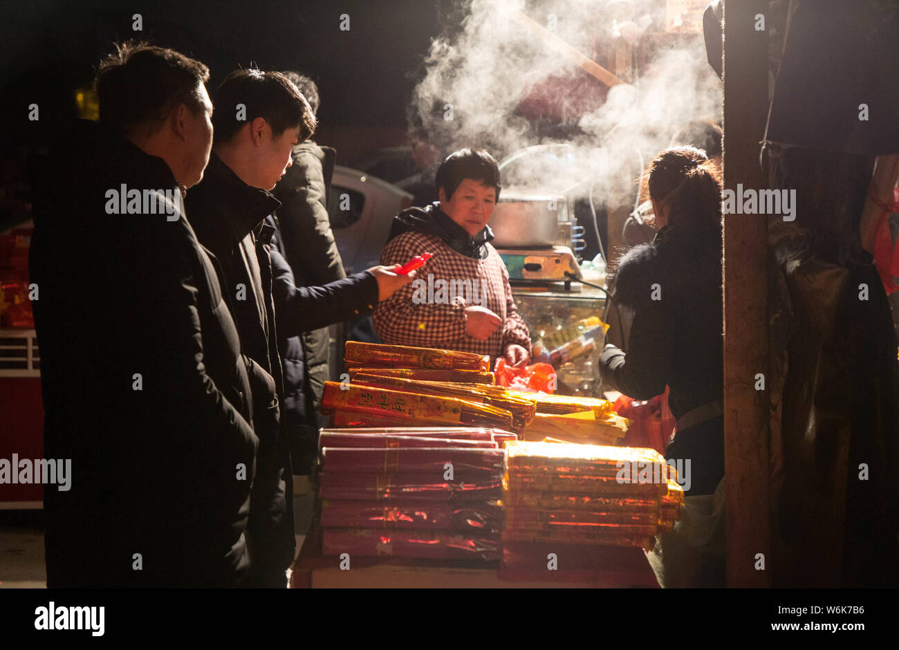 Chinese worshippers burn incense sticks to pray for wealth and