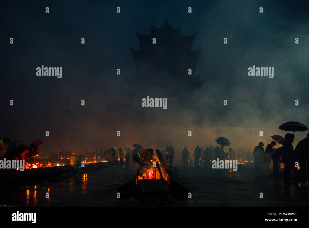 Chinese worshippers burn incense sticks to pray for wealth and
