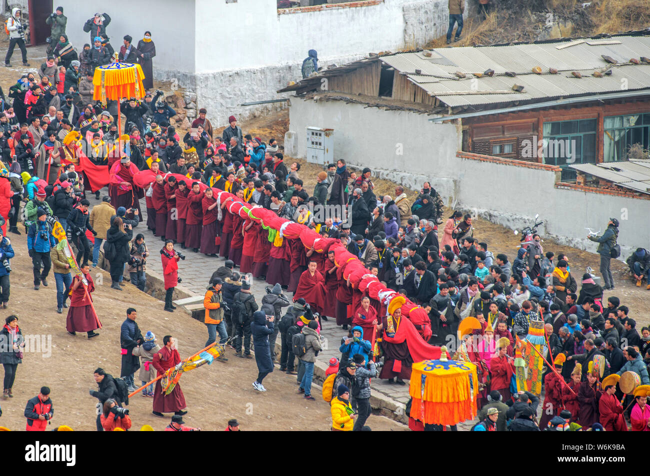 Lamas carry a huge Thangka of Buddha at the Langmu Temple during the ...