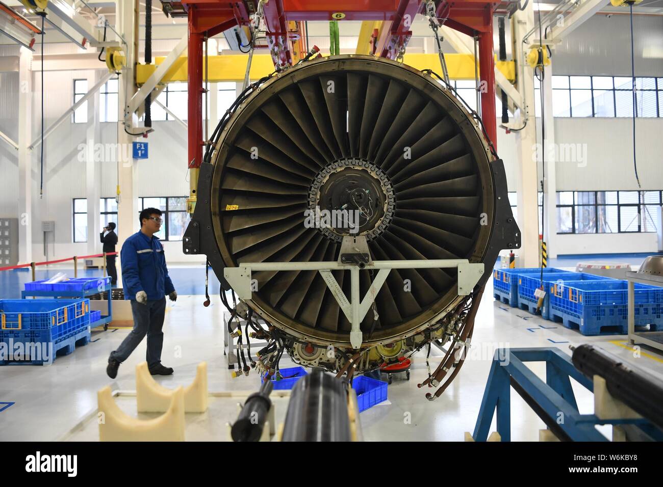 A Chinese worker repairs an aircraft engine at the Sichuan Services ...