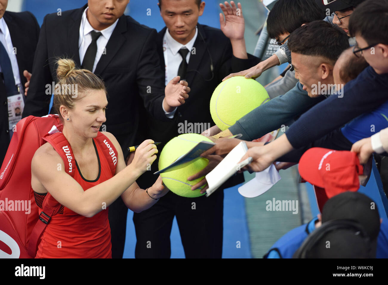 Simona Halep of Romania signs for fans after defeating Aryna Sabalenka