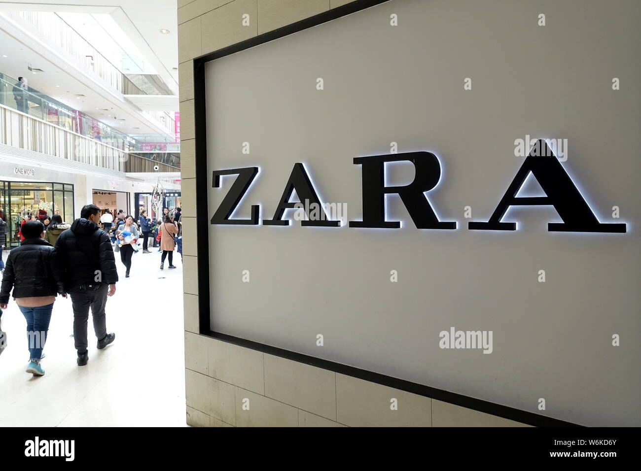FILE--Pedestrians walk past a signboard of fashion retailer Zara in  Shanghai, China, 9 January 2018. The Cyberspace Administration of Shanghai  on Stock Photo - Alamy