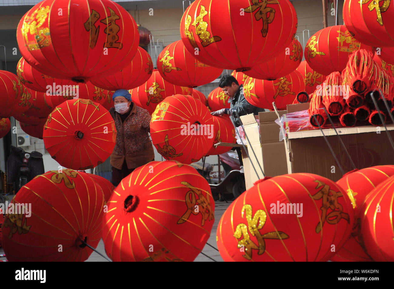 Chinese workers make red lanterns for the upcoming New Year at a ...