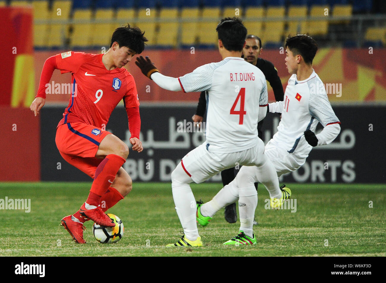 Lee Keun Ho, left, of South Korea kicks the ball to make a pass against Bui Tien Dung and Do Duy Manh of Vietnam in their Group D match during the 201 Stock Photo