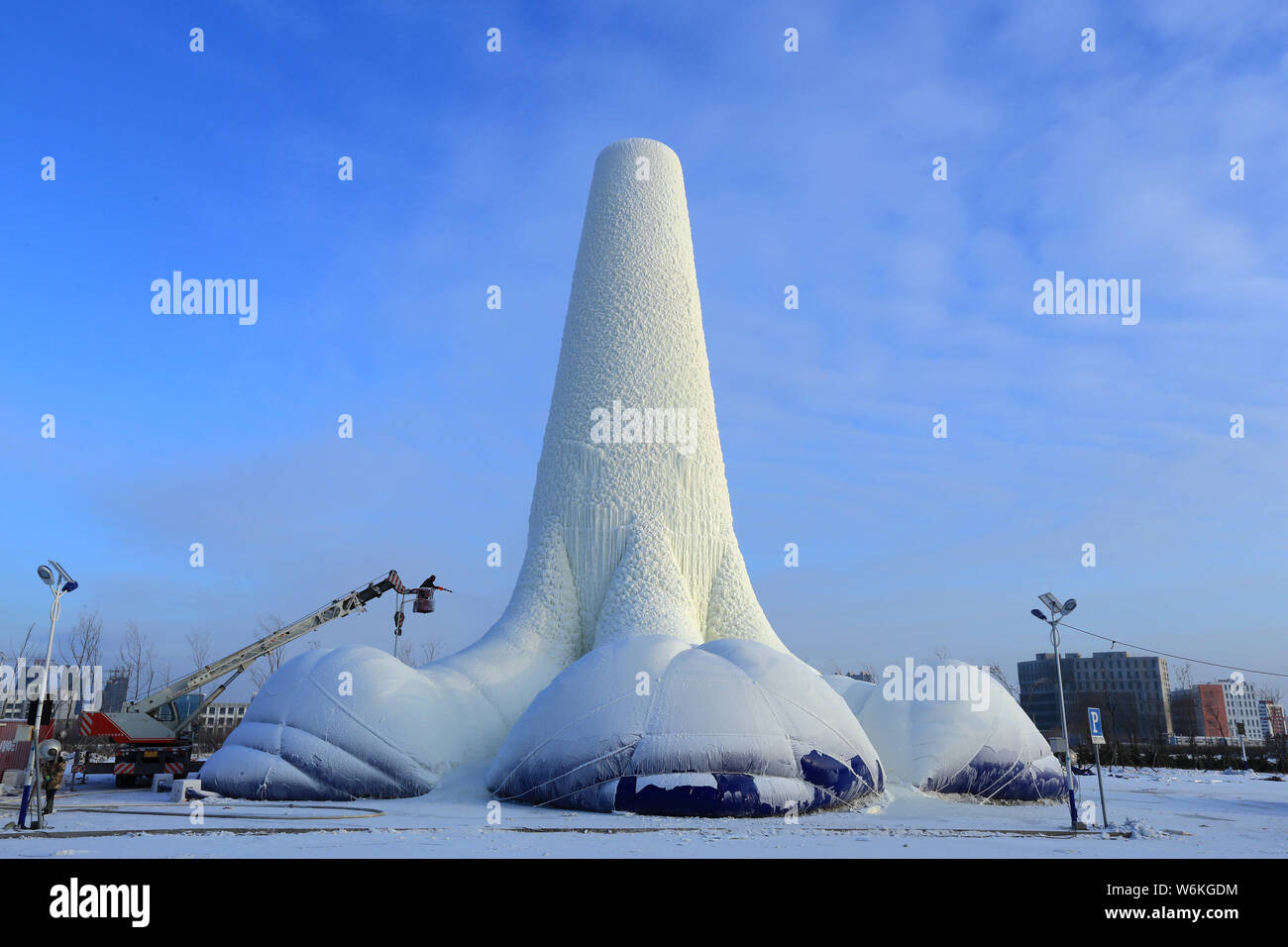 A Chinese worker labors at the world's tallest ice tower, which is 30
