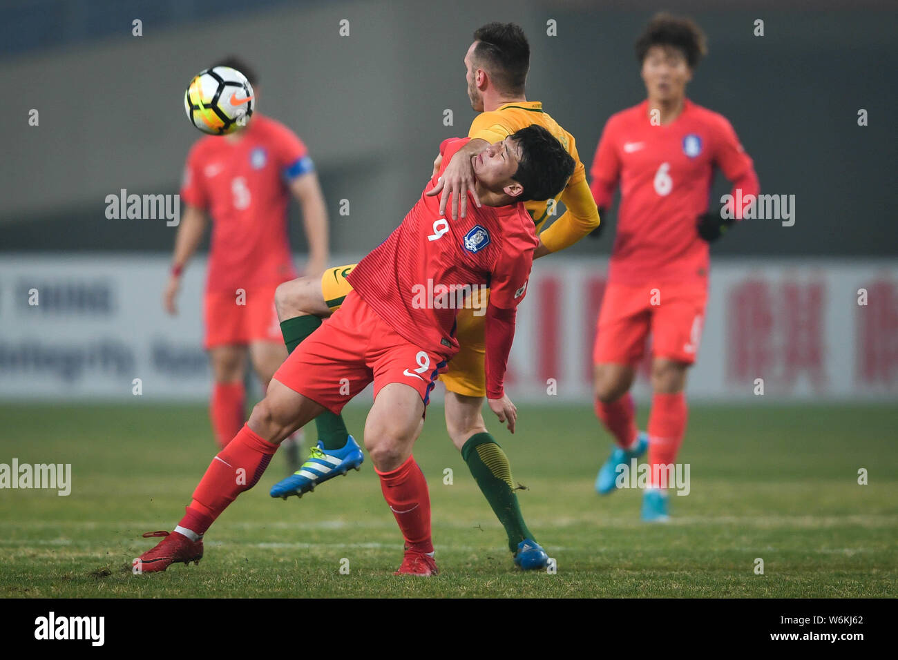 Lee Keun-ho, front, of South Korea challenges a player of Australia in their Group D match during the 2018 AFC U-23 Championship in Kunshan city, east Stock Photo
