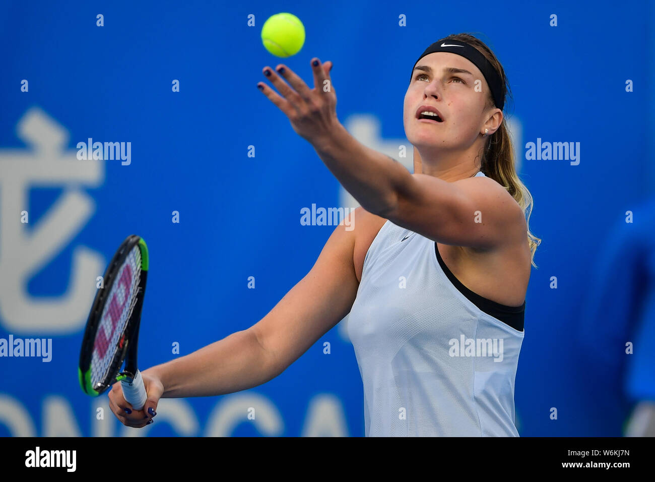 Simona Halep of Romania serves against Aryna Sabalenka of Belarus in