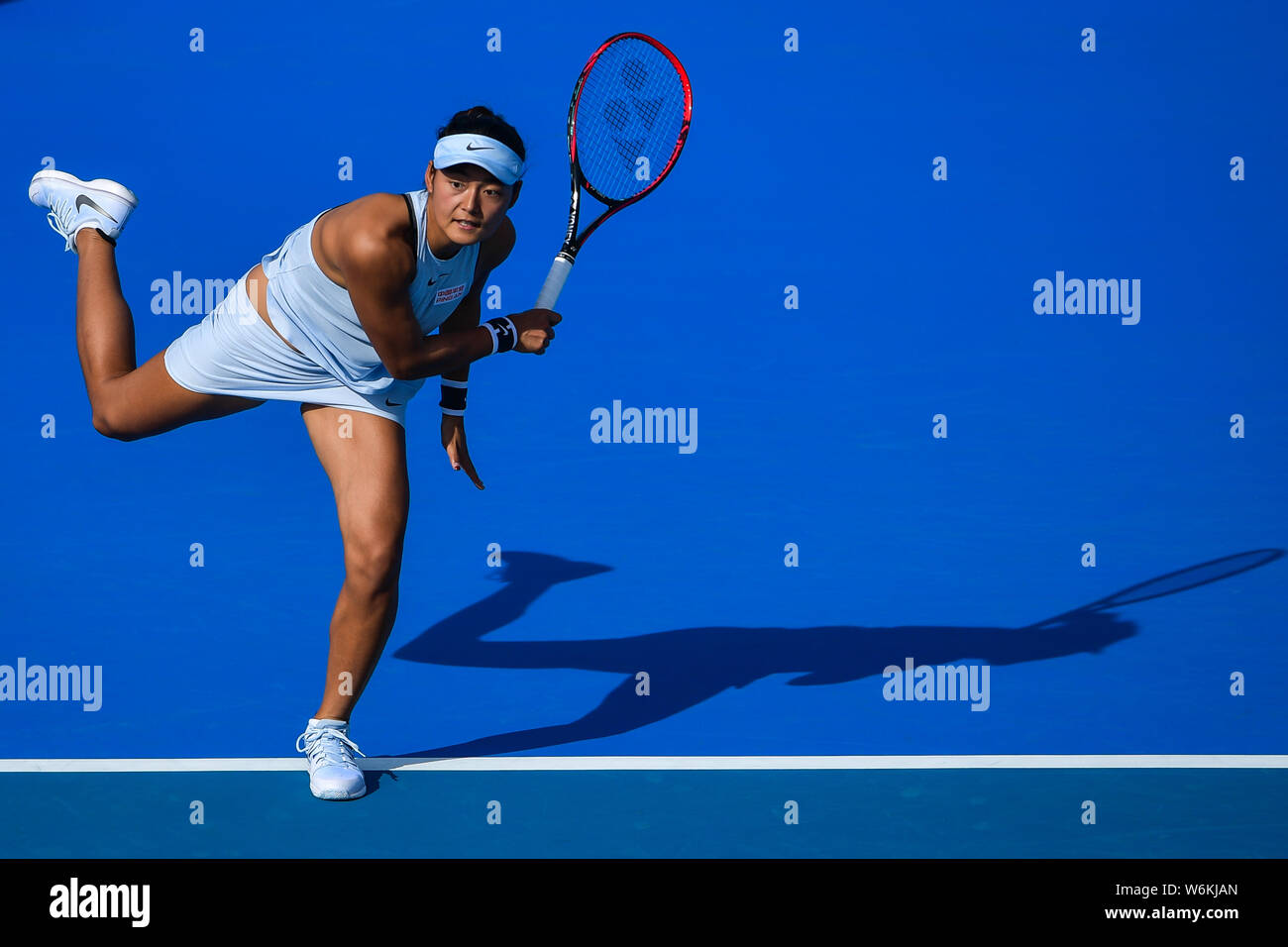 Wang Yafan of China returns a shot to Katerina Siniakova of Czech