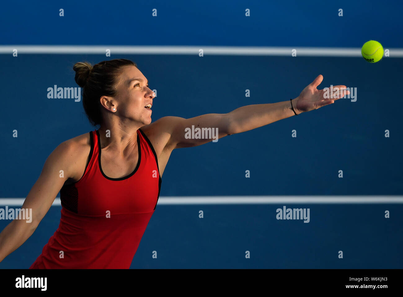 Simona Halep of Romania serves against Aryna Sabalenka of Belarus in