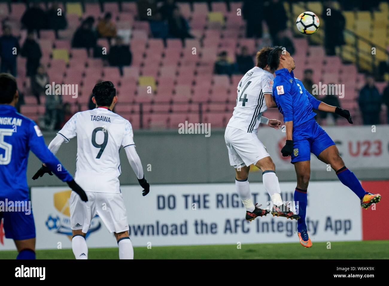 Itakura Kou, left, of Japan heads the ball to make a pass against a player of Thailand in their Group B match during the 2018 AFC U-23 Championship in Stock Photo