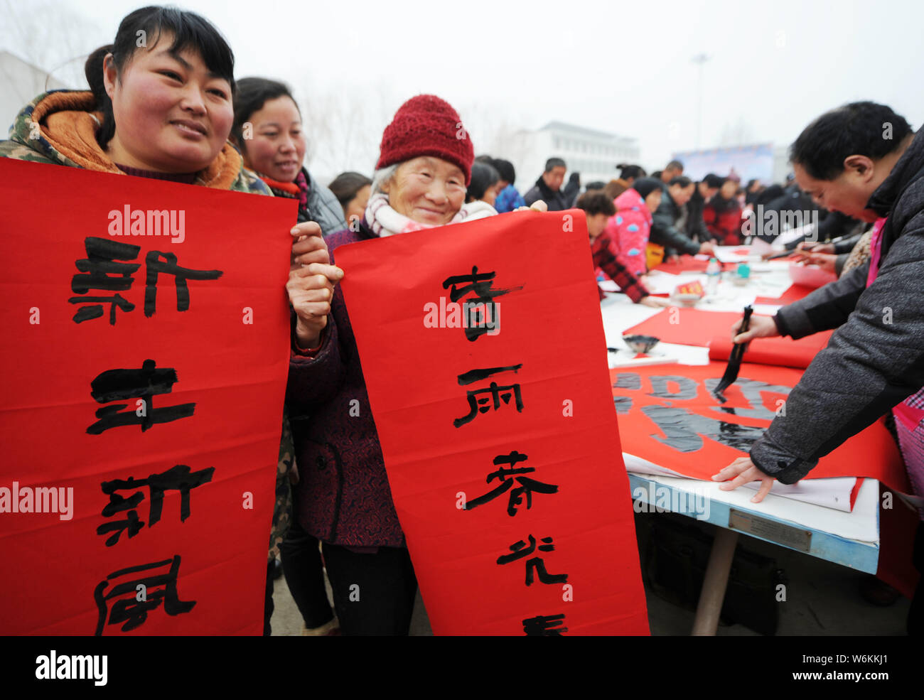 Calligraphers write couplets for the upcoming Spring Festival or the Chinese New Year (Year of the Dog) to villagers at Wuxiaoge village of Bozhou cit Stock Photo