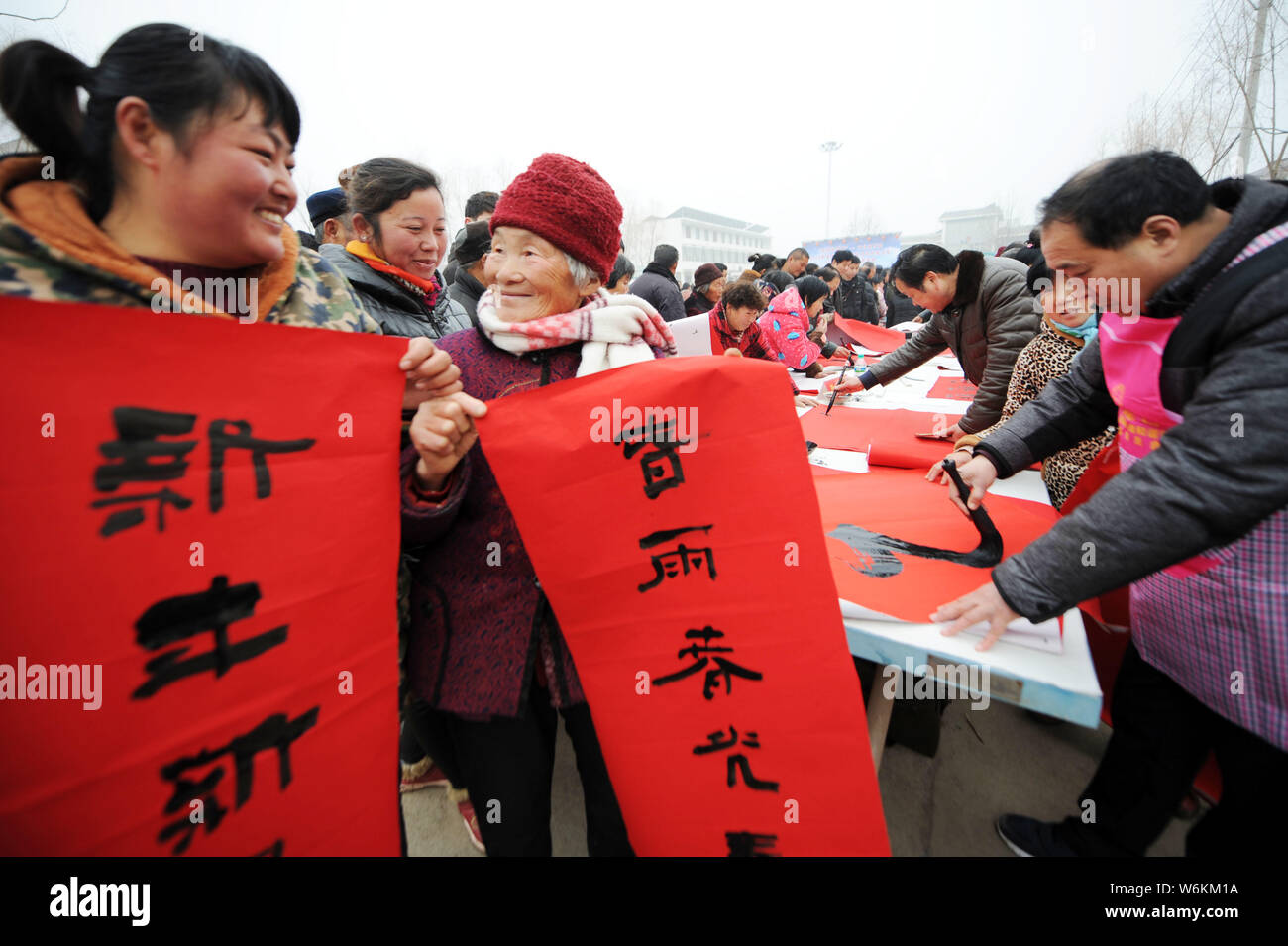 Calligraphers write couplets for the upcoming Spring Festival or the Chinese New Year (Year of the Dog) to villagers at Wuxiaoge village of Bozhou cit Stock Photo