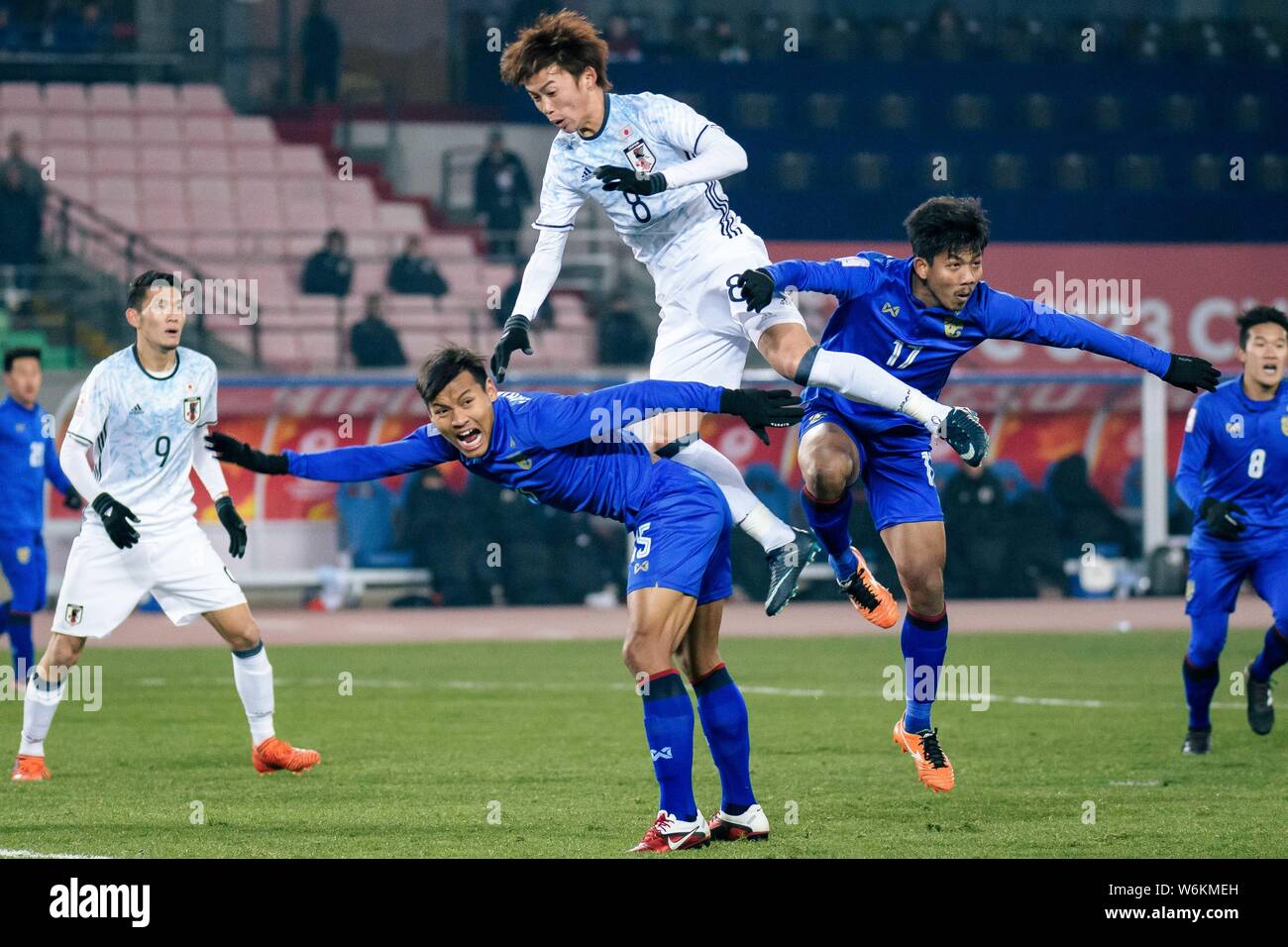 Tsukasa Morishima, top, of Japan heads the ball to make a pass against players of Thailand in their Group B match during the 2018 AFC U-23 Championshi Stock Photo