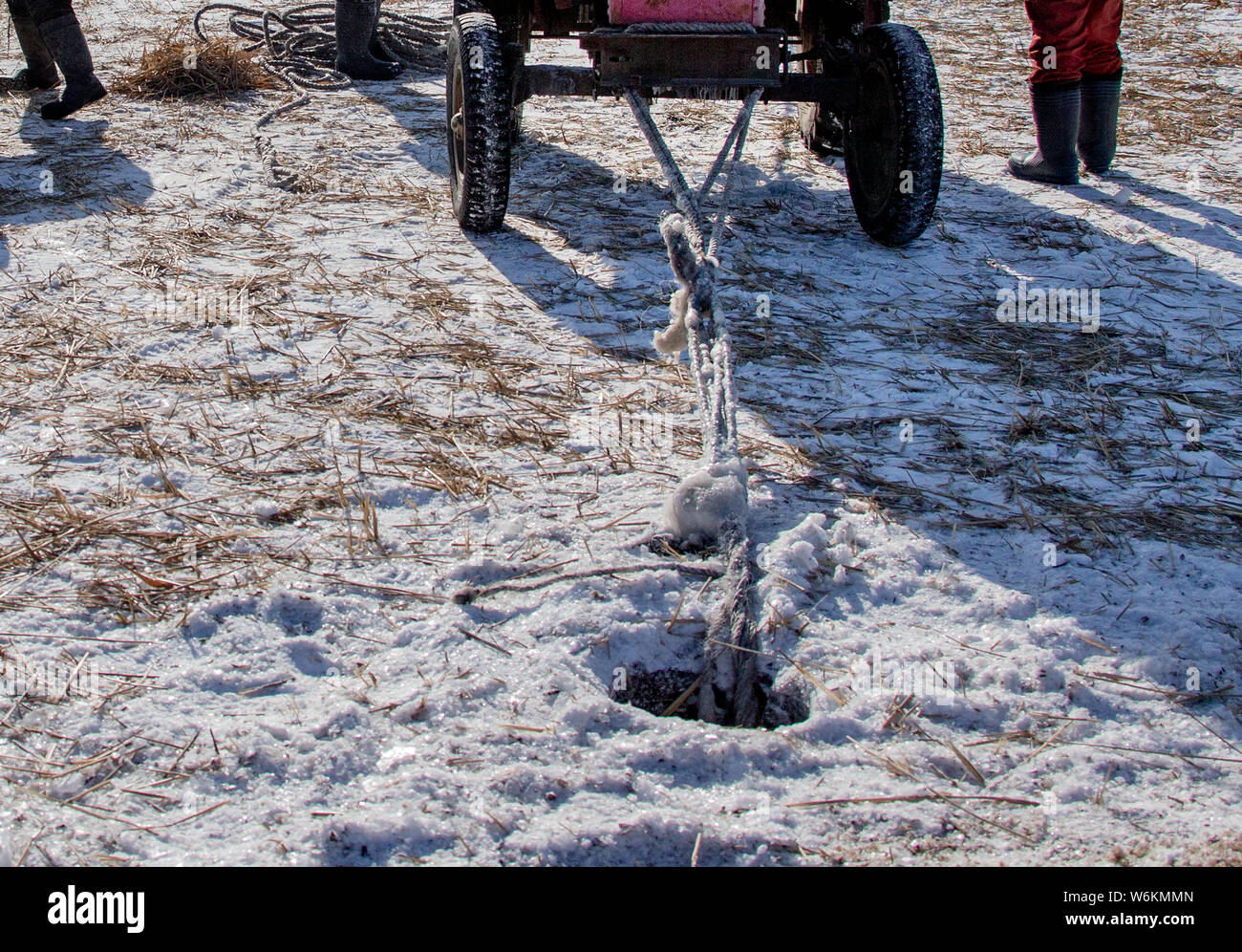 The hole chiselled by Chinese fishmen to harvest fishes is seen during the winter fishing season at the Yaoling lake in Daqing city, northeast China's Stock Photo