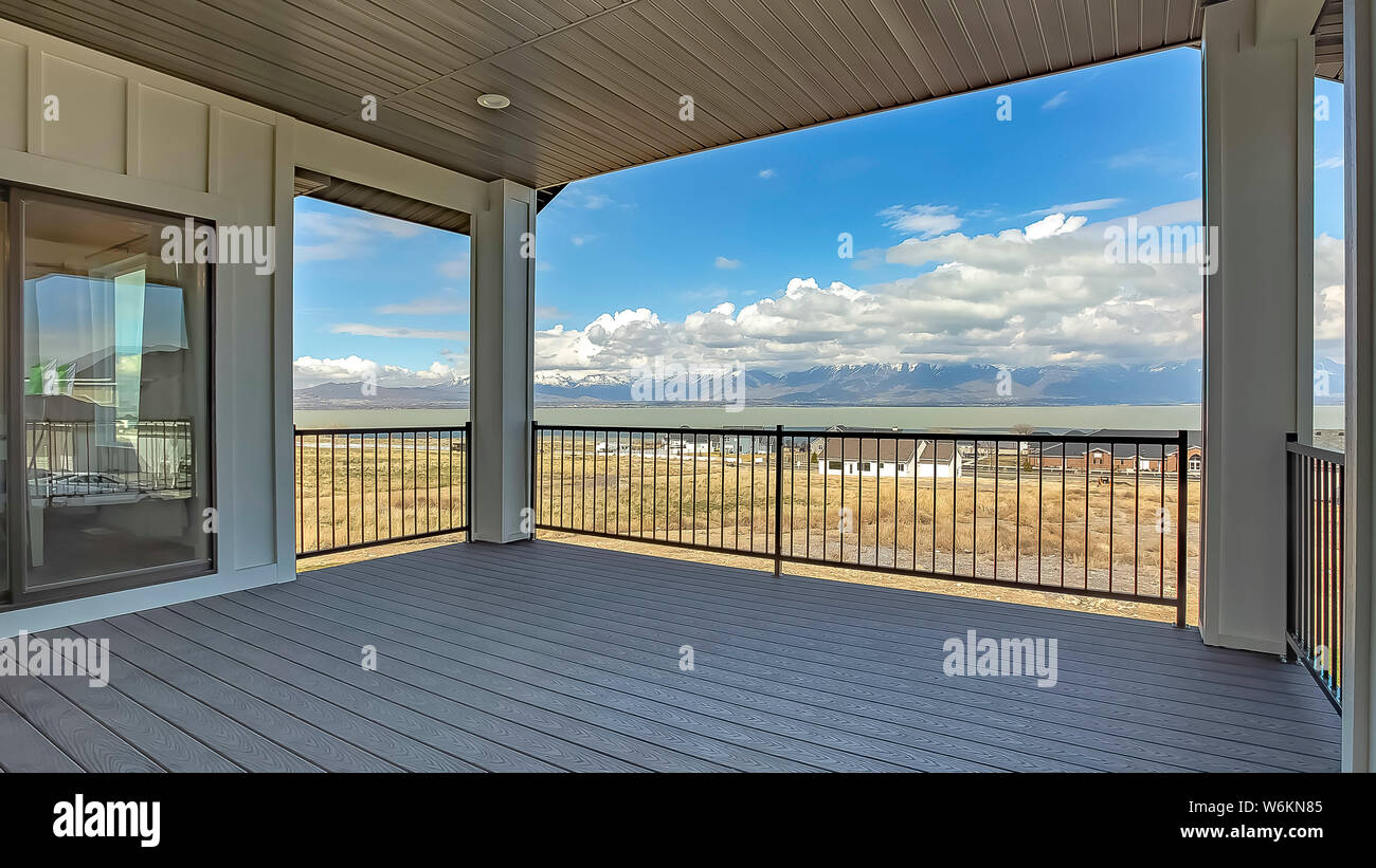 Balcony View Frame Panorama frame Balcony with view of cloudy blue sky over homes lake and ...