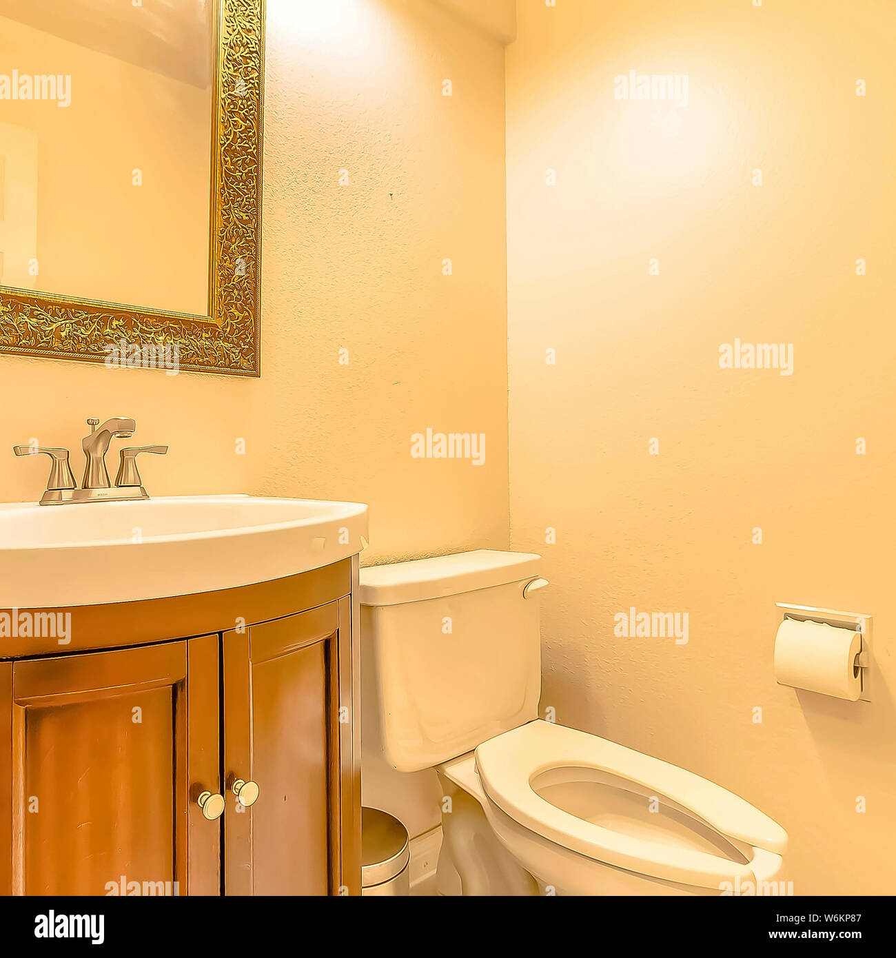 Toilet And Sink Inside The Bathroom Of A House With Cream Colored