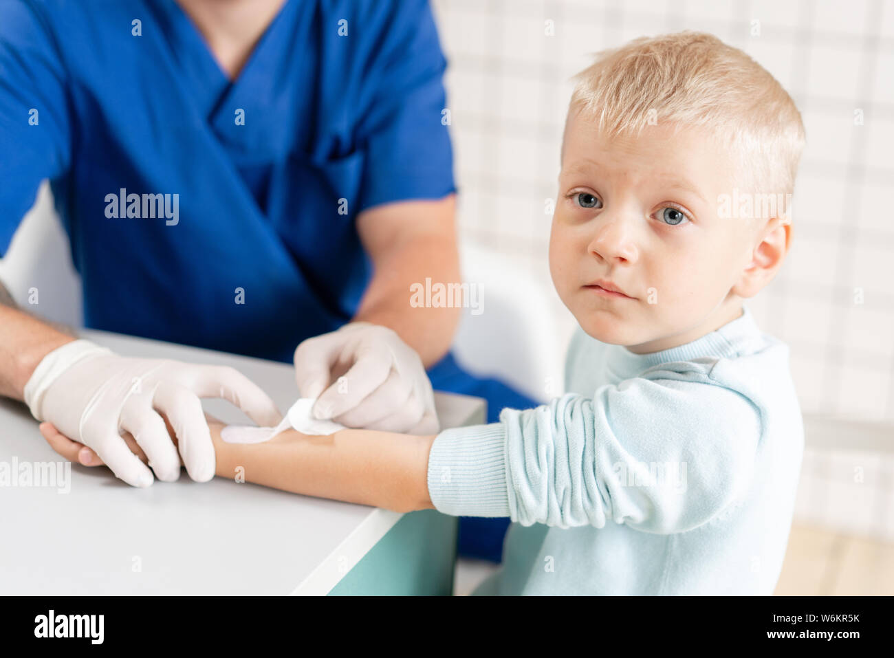 medical patch. Doctor bandaged a boy hand with trauma in his arm