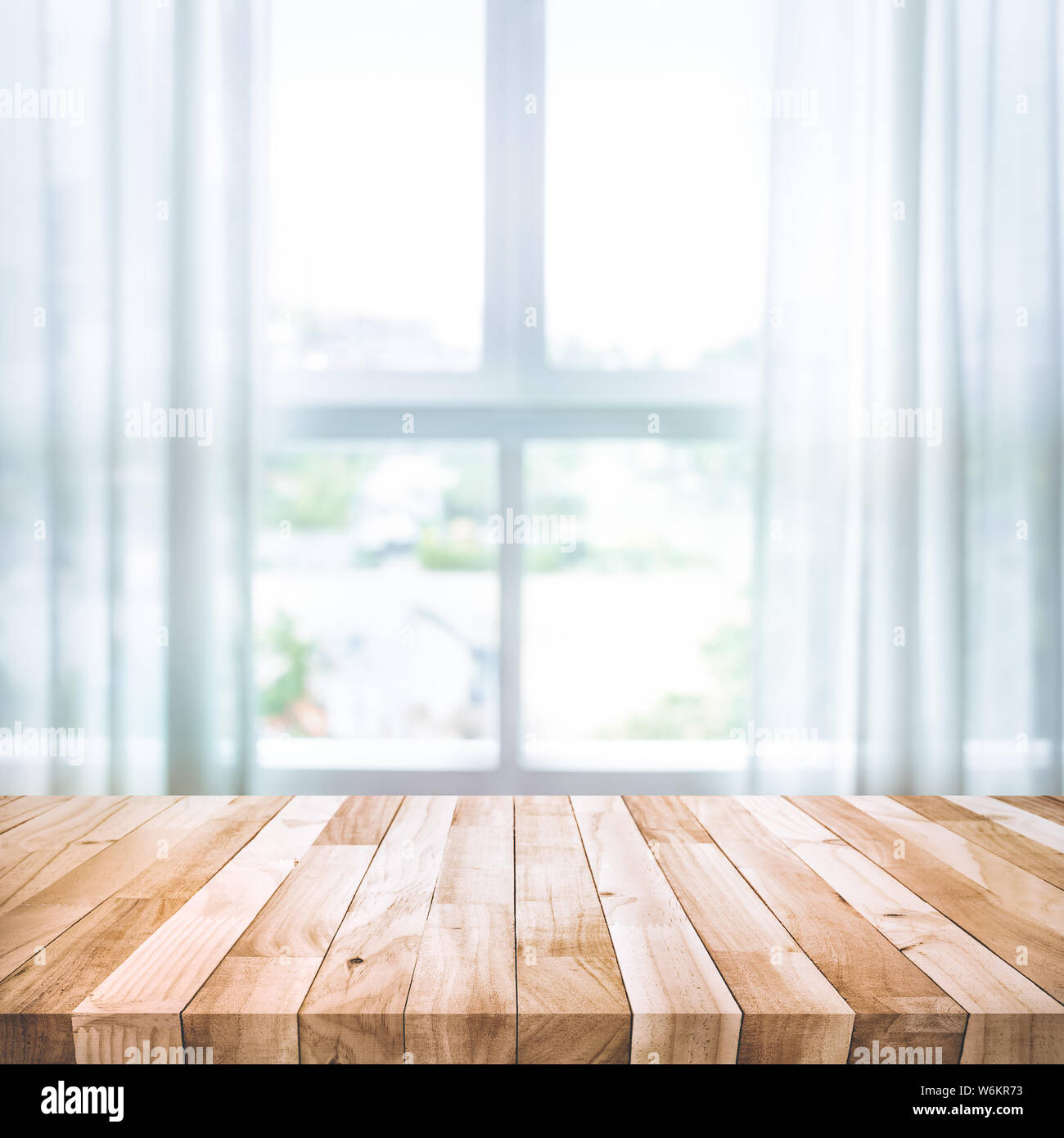 Empty of wood table top on blur of white curtain with window view background.For montage product display or design key visual layout Stock Photo