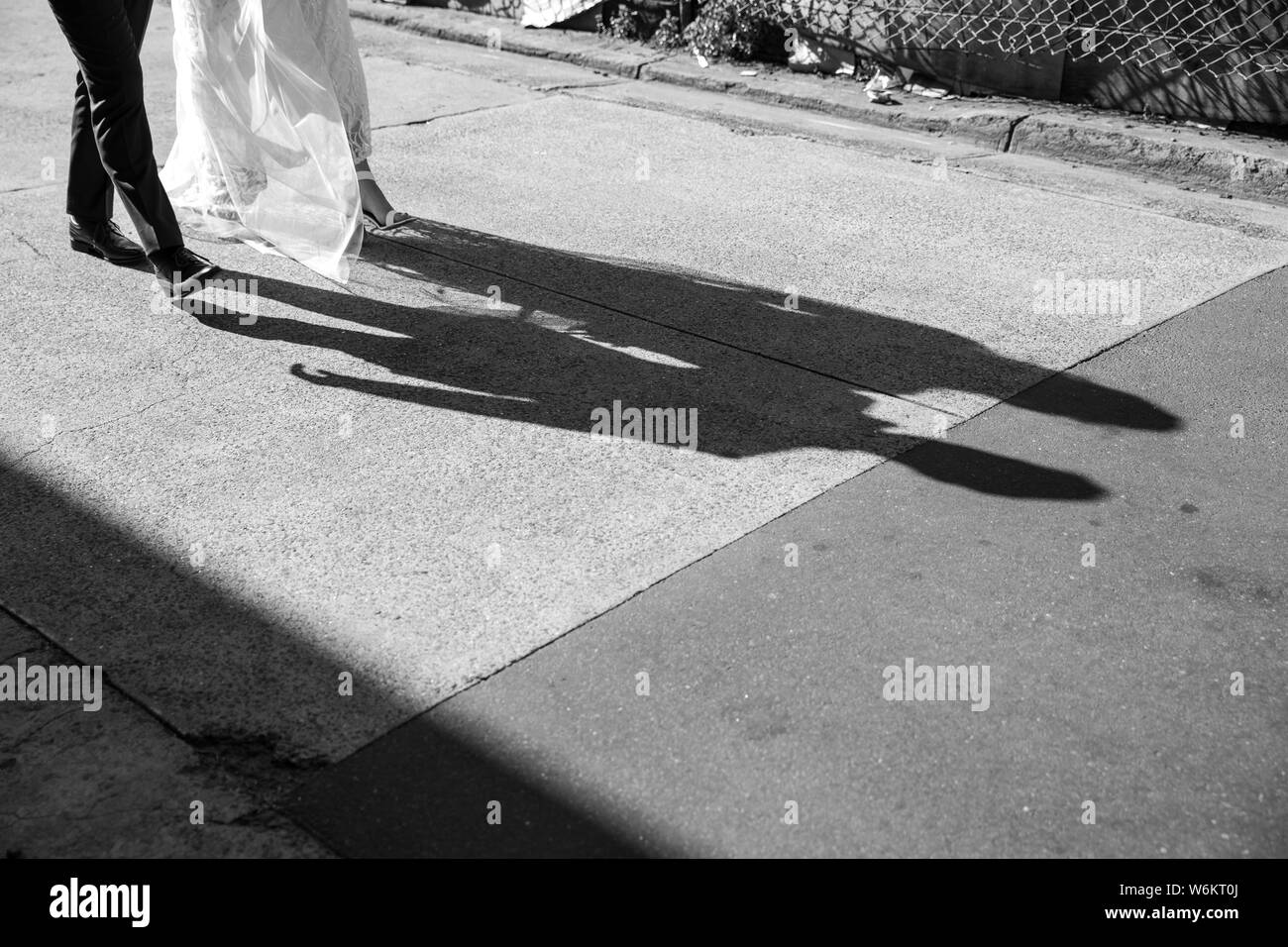 Bride and groom walking down street Stock Photo - Alamy