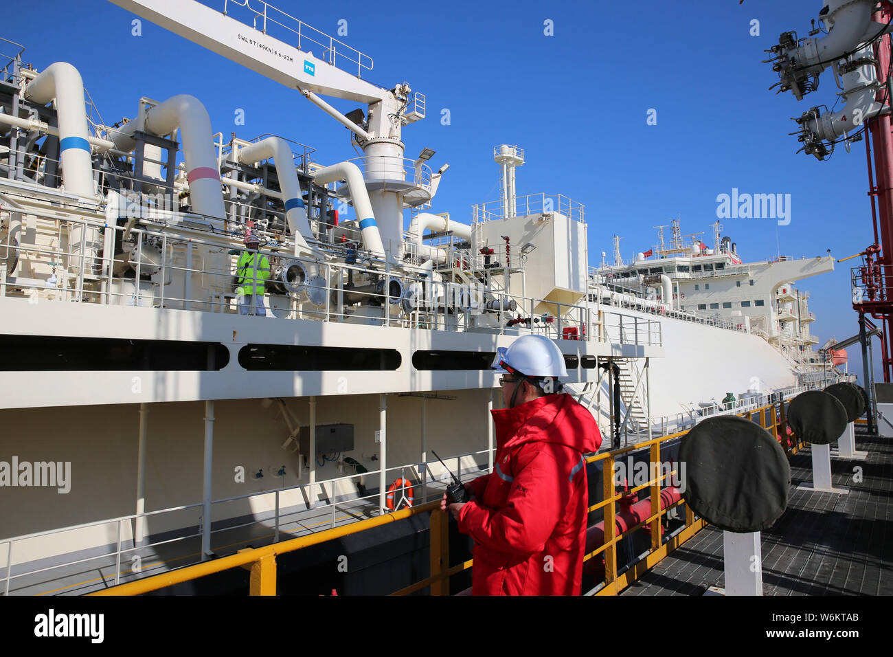 A Chinese Worker Directs As The Australian Liquefied Natural Gas Lng