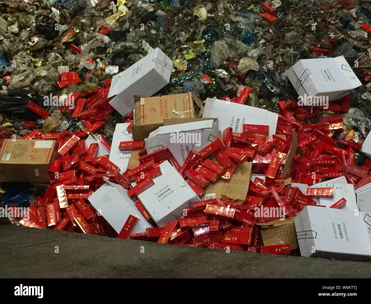 2,333 cartons of counterfeit Zhonghua brand cigarettes are being destroyed in an incinerator during a winter operation in Zhenjiang city, east China's Stock Photo