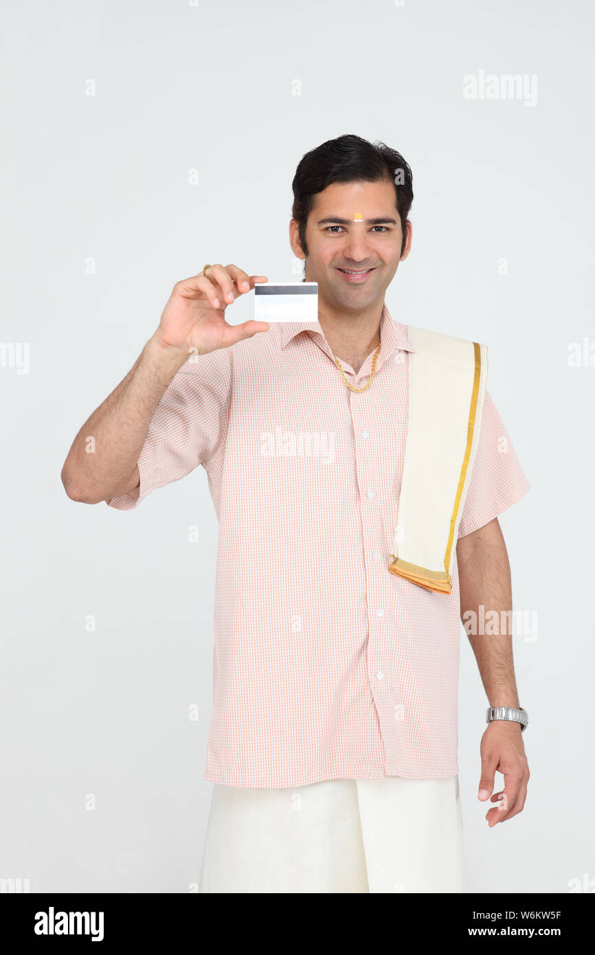 South Indian man showing a credit card Stock Photo - Alamy