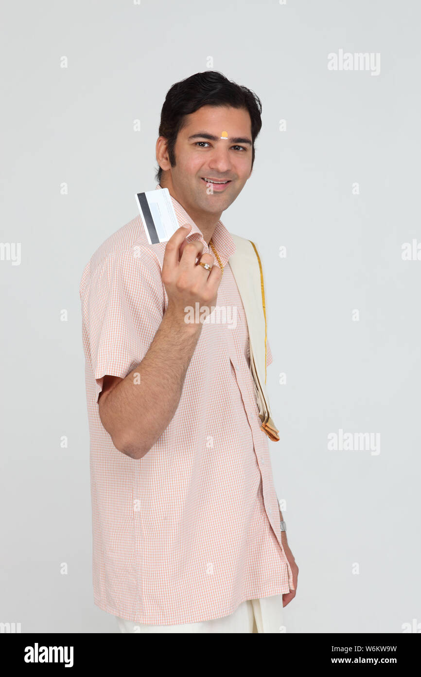 South Indian man showing a credit card Stock Photo - Alamy
