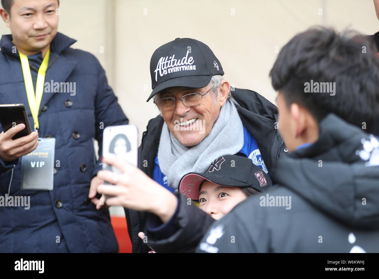 Serbian football coach and former player Bora Milutinovic, center, poses with fans for photos at a press conference of Sina 5v5 Football Golden League Stock Photo