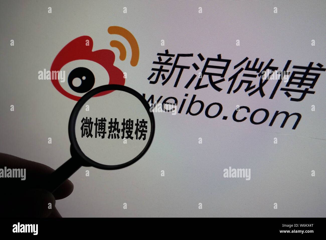 --FILE--A Chinese netizen looks at a logo of Weibo, the Twitter-like ...