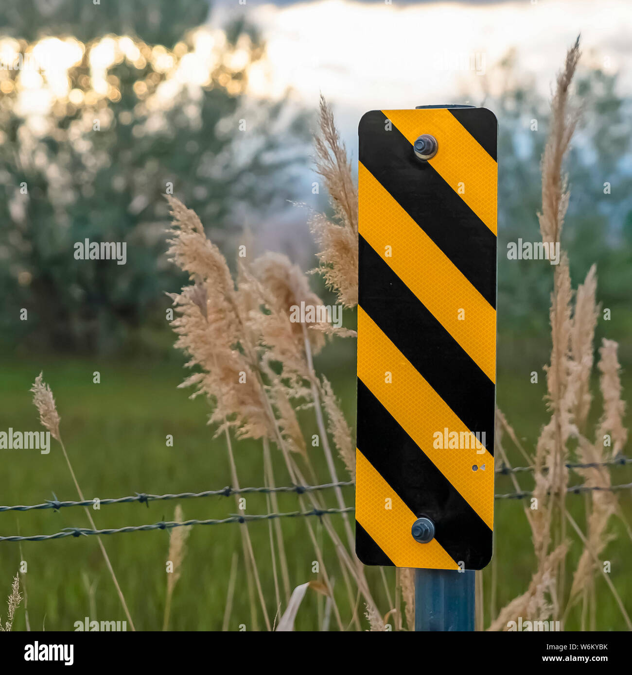 Square frame Close up of black and yellow diagonal stripes road sign