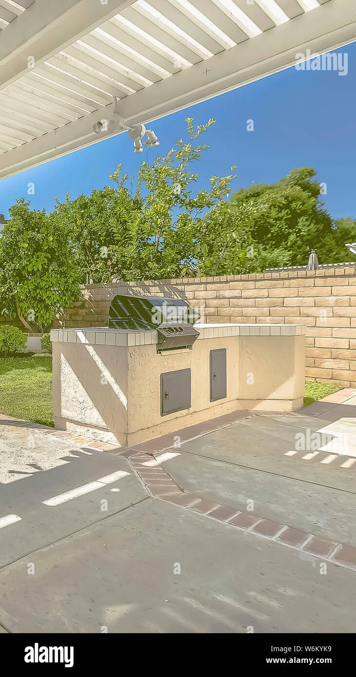 Vertical Frame Concrete Patio Of A Home With Barbecue Grill And