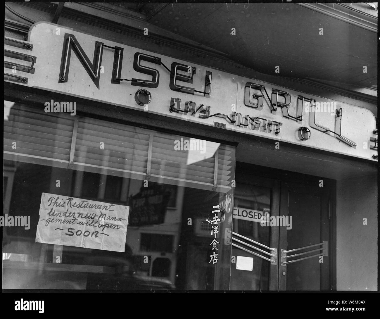 San Francisco, California. This restaurant, named Nisei after second- generation children born in . . .; Scope and content:  The full caption for this photograph reads: San Francisco, California. This restaurant, named Nisei after second- generation children born in this country to Japanese immigrants was closed prior to evacuation of residents of Japanese ancestry; and, according to sign in the window, was scheduled to re- open under new management. Evacuees will be housed at War Relocation Authority centers for [the] duration. Stock Photo