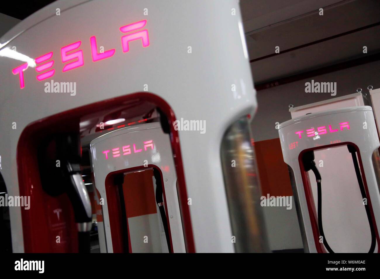 --FILE--View of logos at the world's largest Supercharger station of Tesla inside an underground parking garage in Pudong district, Shanghai, China, 2 Stock Photo