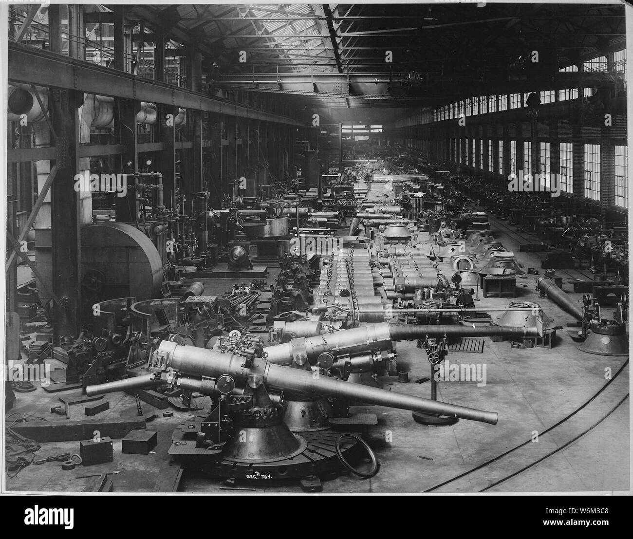 Shop Number 2 annex. 6 inch guns with their mounts in foreground; immediately in the rear, slides or cradles for 10 inch, 12 inch, and 14 inch guns. Bethlehem Steel Company. Bethlehem Steel Company., ca. 1918; English: The 6-inch guns in the foreground are US Army M1900 guns on the M1900 pedestal mount with shields removed; they are possibly about to be mounted on field carriages for service in France. Alternatively, the photo may date from circa 1905, when this type of weapon was being manufactured. General notes:  Use War and Conflict Number 555 when ordering a reproduction or requesting inf Stock Photo