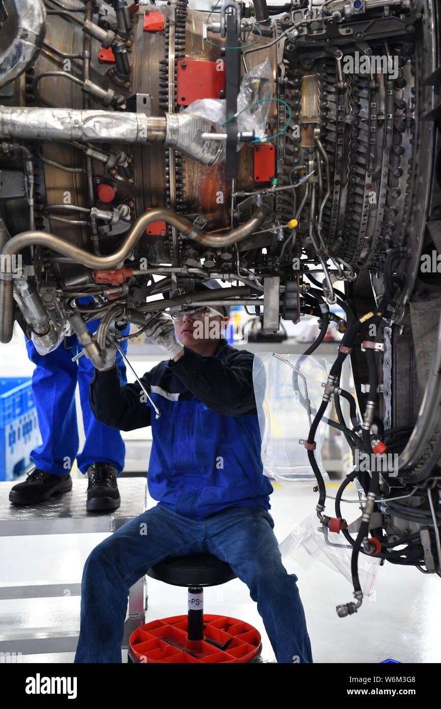A Chinese worker repairs an aircraft engine at the Sichuan Services ...