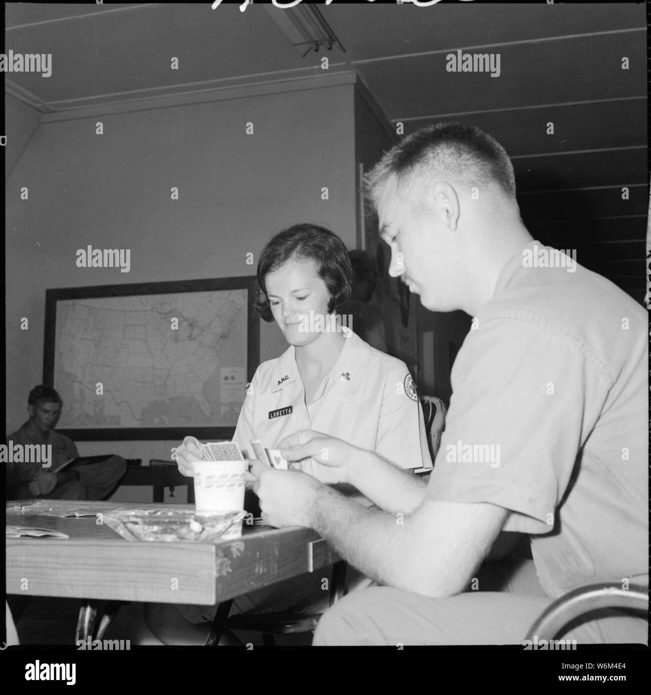 South Vietnam....Loretta Clause plays cards, talks, etc., with Marines of H&S, 1st Marine Division. She is a volunteer worker for the Red Cross. Stock Photo