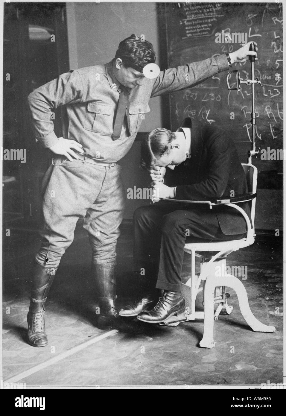 Subjecting the prospective American airman to the falling test. The ...