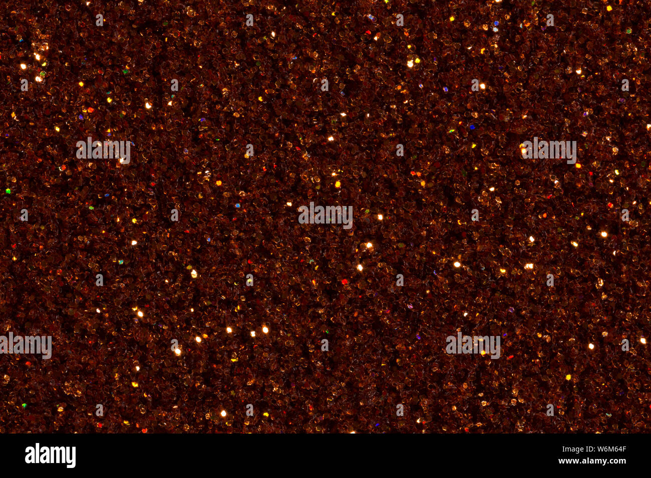 Saturated brown, dark orange colour background with glitter. High