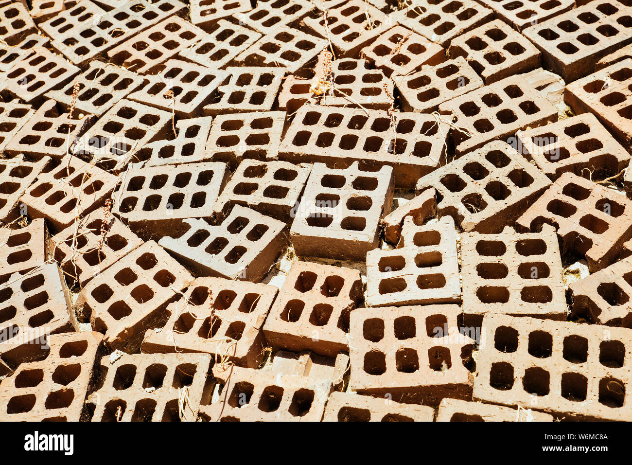 close-up pile of bricks with drilled holes. Materials construction Stock Photo