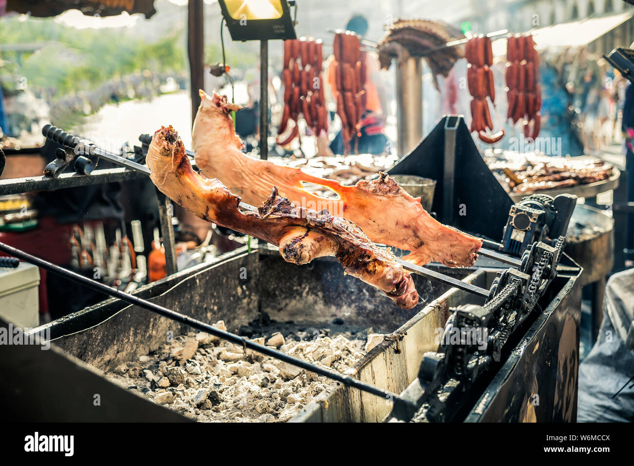 view of pig grilled on spit over the embers Stock Photo