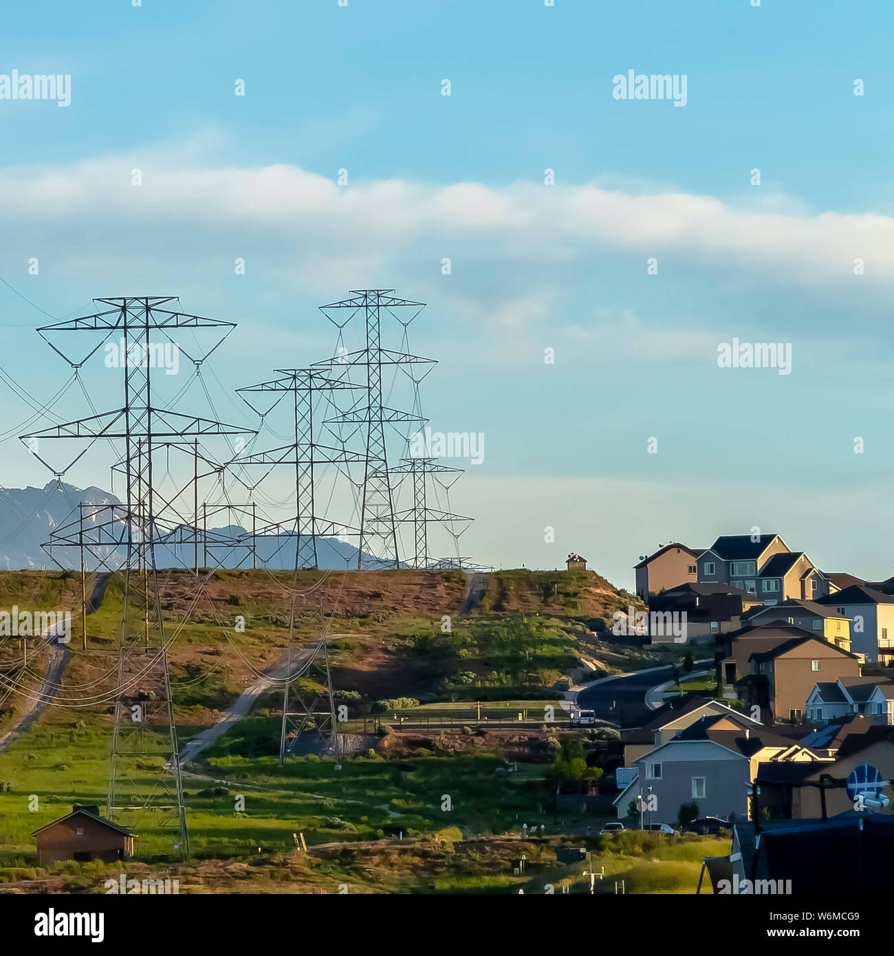 Square Power lines towering over neighborhood and roads in the valley ...