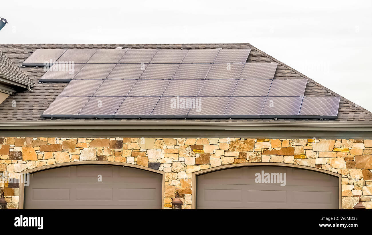 Panorama frame Solar panels installed on the garage roof of a home with