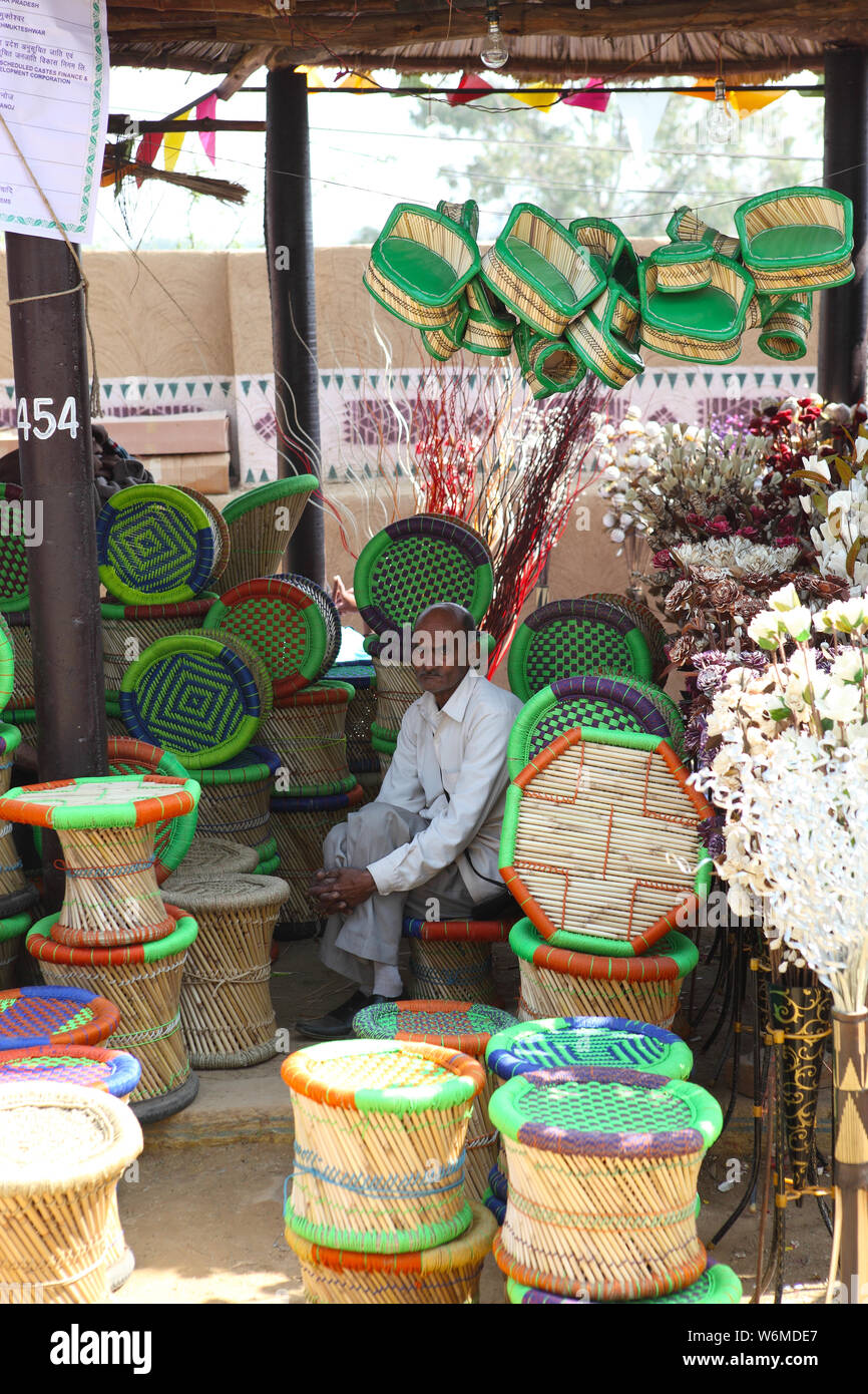 Shopkeeper selling moodas at Surajkund Crafts Mela, Surajkund, Faridabad, Haryana, India Stock Photo