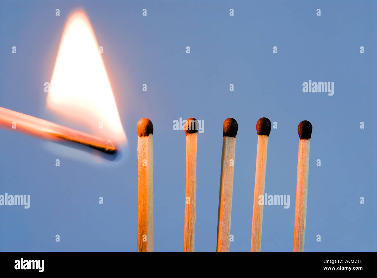 Setting on fire a line of matches Stock Photo