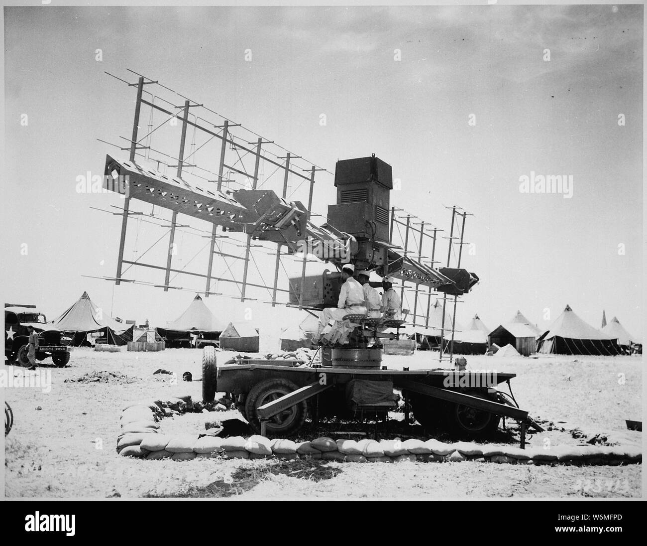 Three soldiers of the United States Army sit in place at a radar used by the 90th Coast Artillery in Casablanca, French Morocco., 06/19/1943 (Operate is more correct) (the 90th CA (Antiaircraft) was an African-American unit) Stock Photo