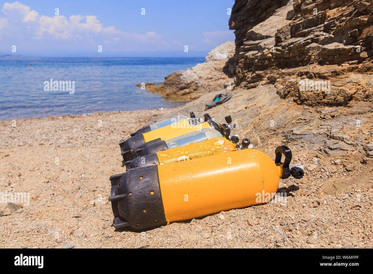 Scuba diving compressed air tanks on sand beach. Summer holiday